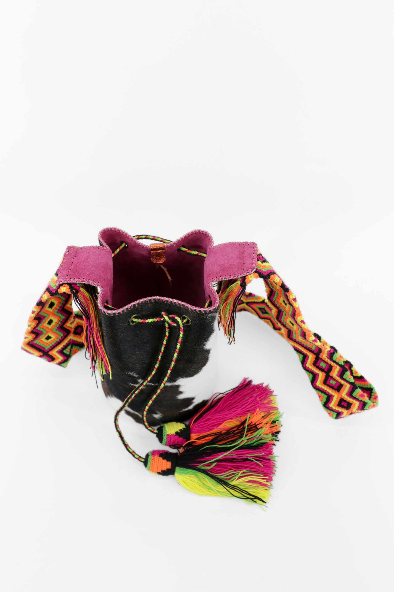 Detalle del interior del bolso con estampado de vaca y cuero fucsia